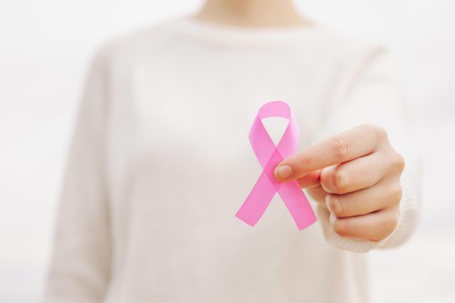 woman-with-pink-ribbon-cancer-symbol-her-hand-(1).jpg